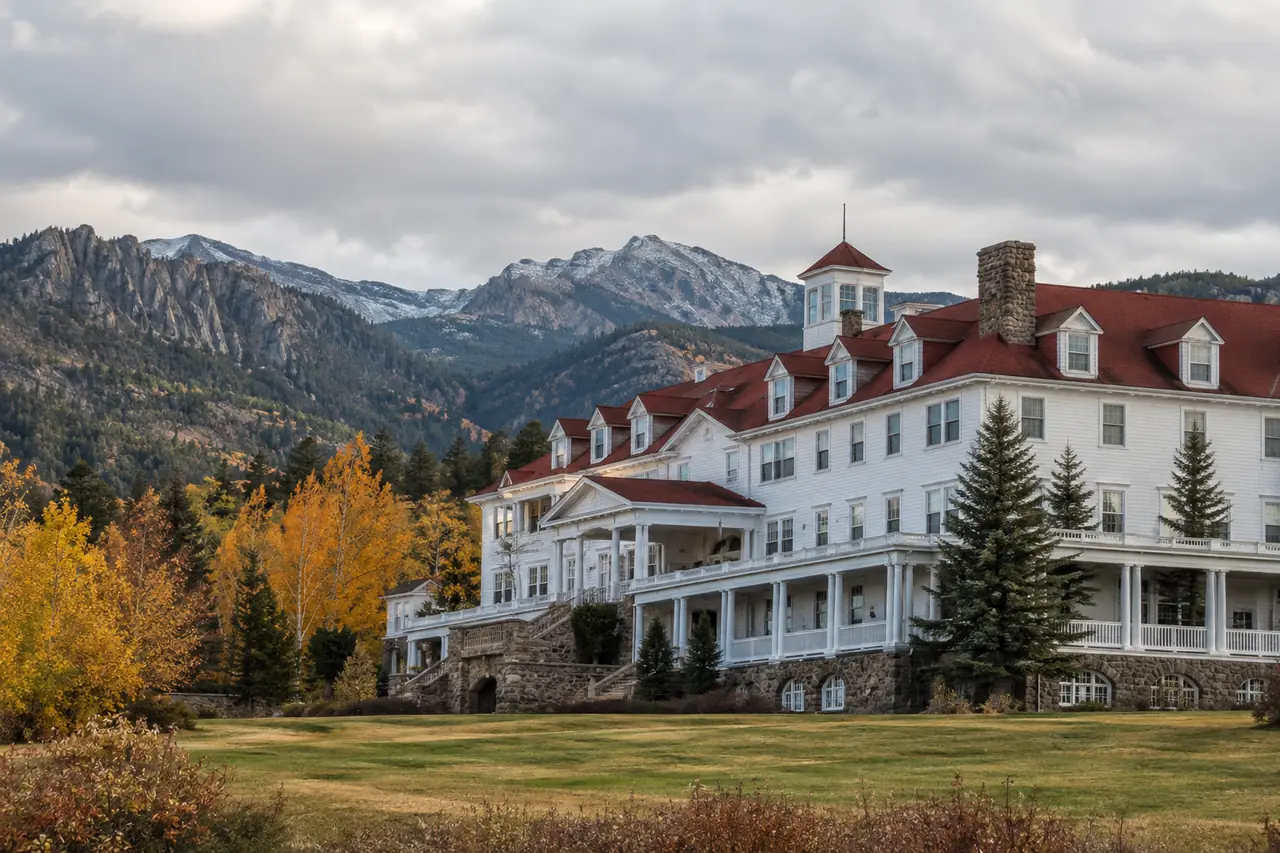 A historic mountain hotel surrounded by autumn trees